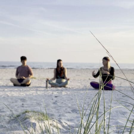 Winnie Bothe teaching yoga on the beach during Kundalini Awakening Retreat Sweden, guiding participants in energy awakening and balance.