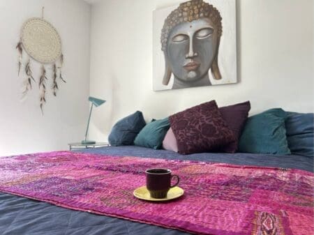 Cozy bedroom at Yogi Living guesthouse in Skåne, Sweden, inviting rest and relaxation.