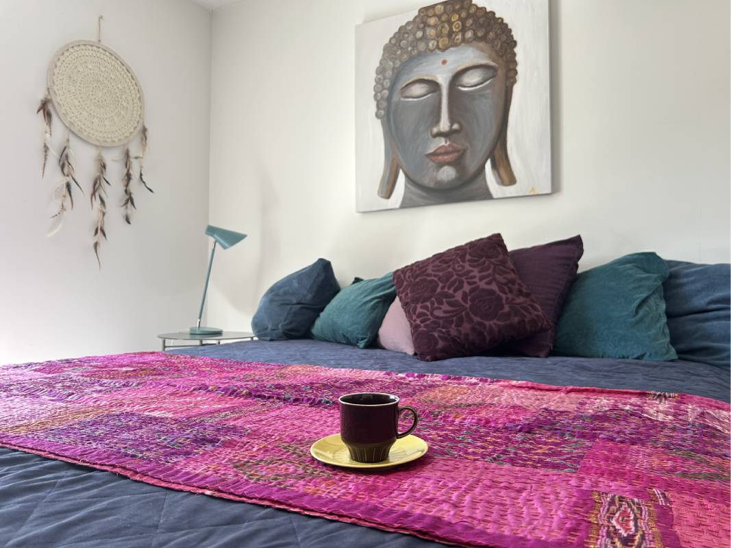 Cozy bedroom at Yogi Living guesthouse in Skåne, Sweden, inviting rest and relaxation.