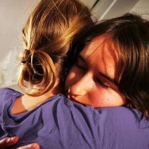 Couple in soulful embrace during Tantra retreat in Sweden, discovering love and trust.