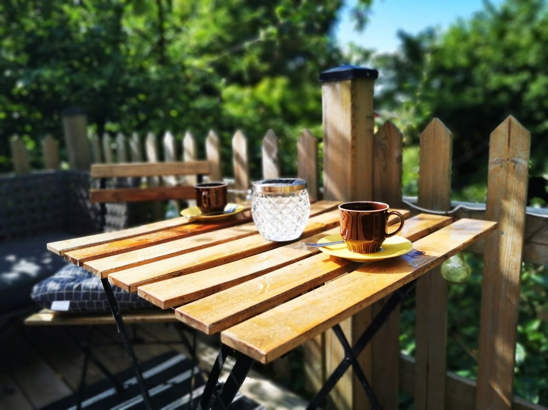 Balcony overlooking the garden and fields at Yogi Living Guesthouse in Skåne, Sweden, ideal for peaceful relaxation