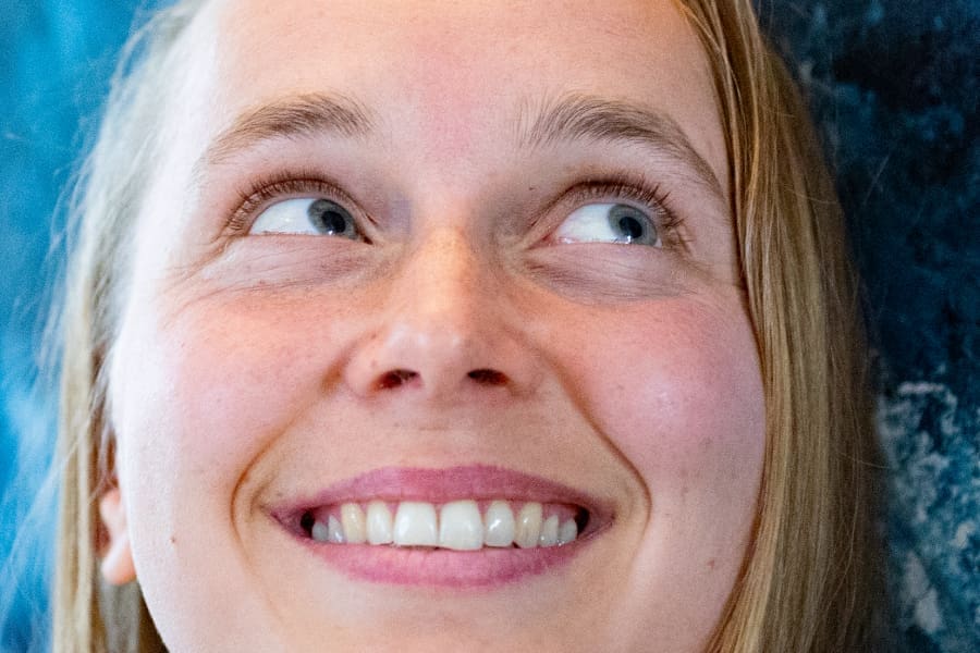 Smiling woman radiating joy and presence during Couples Tantra Yoga retreat in Sweden.