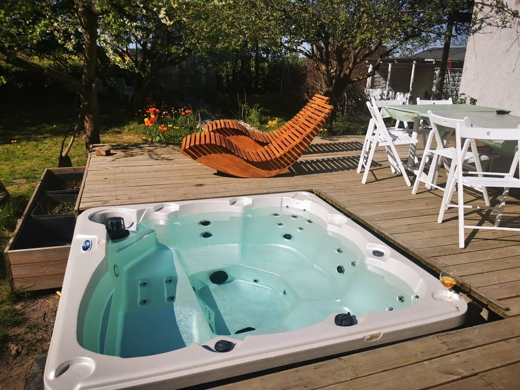 Outdoor jacuzzi terrace at Yogi Living Guesthouse in Skåne, Sweden, perfect for relaxation after yoga sessions