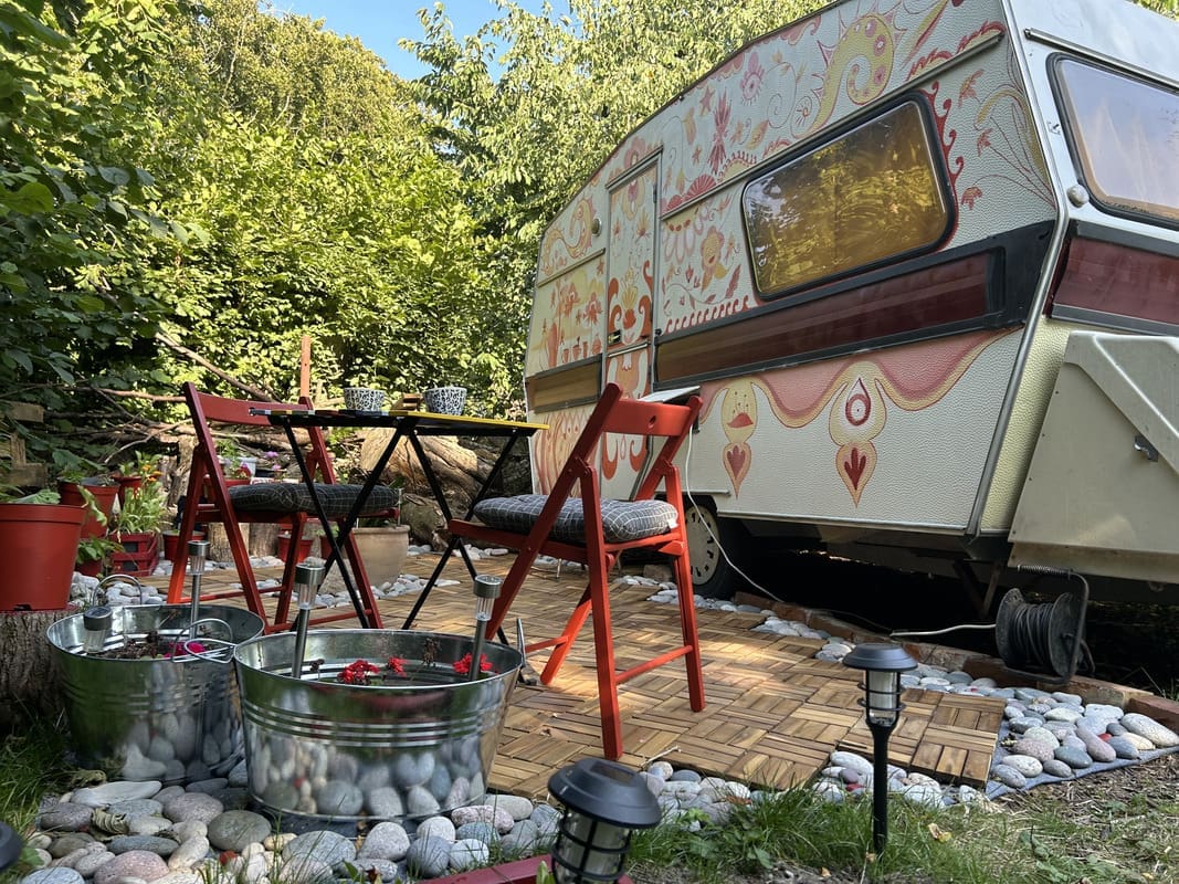 Outdoor terrace of Boho Caravan at Yogi Living retreat center in Skåne, Sweden, ideal for yoga and nature connection