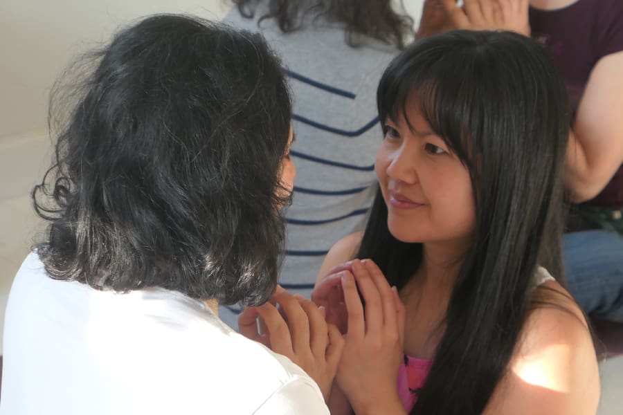 Couple practicing eye gazing to deepen love and connection during a couples yoga retreat in Sweden