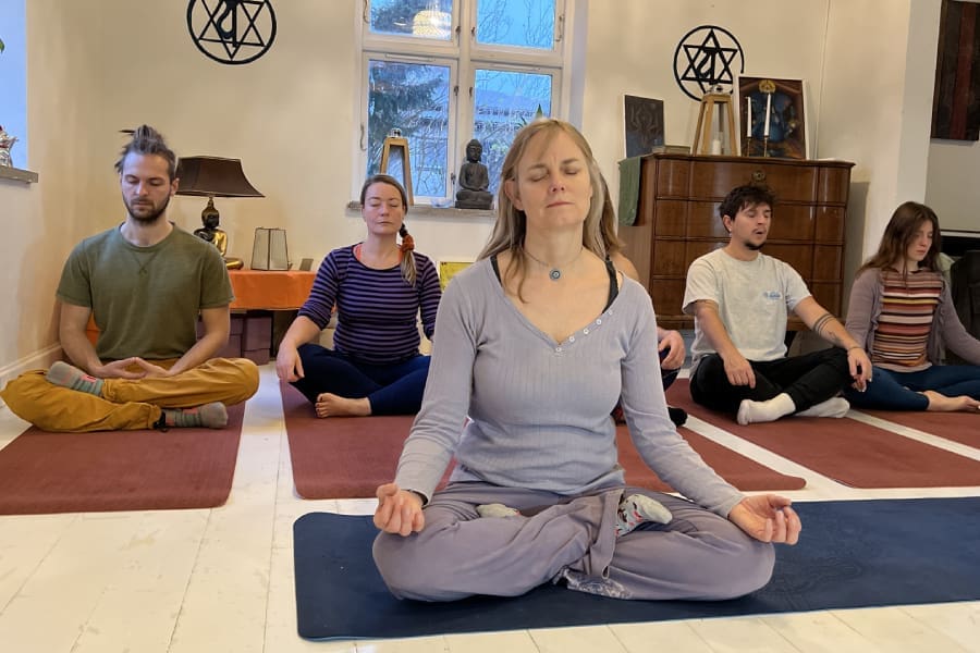 Group meditating during the Kundalini Awakening Retreat in Sweden, focusing on energy flow and inner transformation
