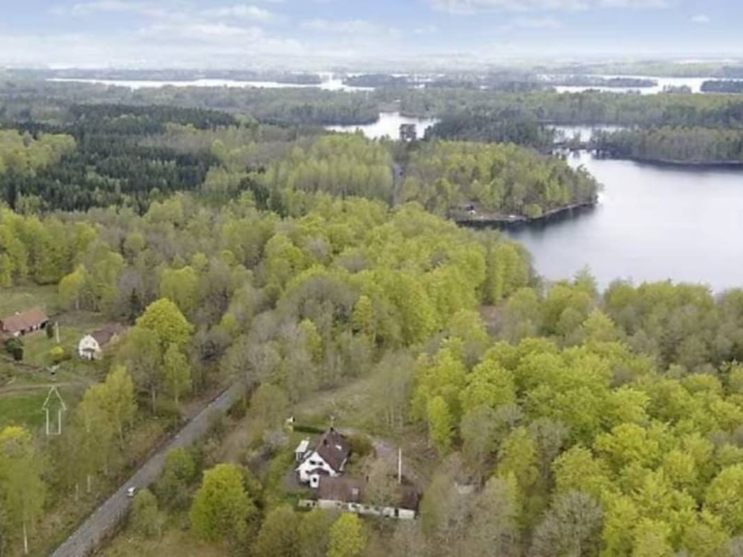 Aerial view of Yogi Living Retreat Center in Sweden surrounded by forest and lake during a Tantra Yoga Retreat