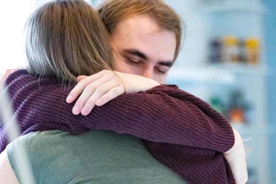 Couple in soulful embrace during Tantra retreat in Sweden, rediscovering love and trust.