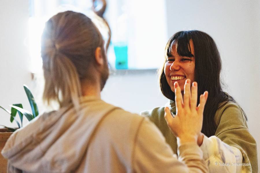 Couple practicing Venus kriyas during Tantra retreat in Sweden, sharing laughter and heart connection.